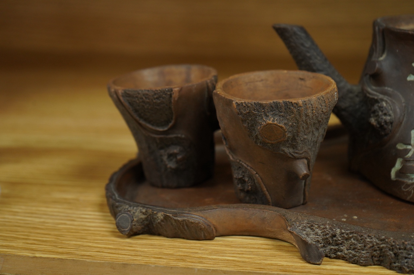 A Chinese naturalistic Yixing teapot, two cups and tray, early 20th century, 25cm high. Condition - fair/good